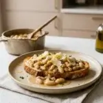 Brothy white beans on sourdough toast with Parmesan and lemon zest