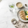 High protein foods for weight loss including grilled chicken, eggs, and gelatin on marble surface