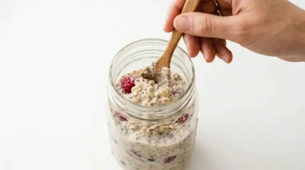 Stirring overnight oats in a mason jar — Valerie Bertinelli oat trick preparation step
