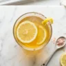 Lemon gelatin trick recipe for weight loss in glass with fresh lemon slices