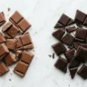 Milk chocolate vs dark chocolate side by side comparison on white marble