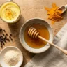 Neuro honey blend recipe ingredients including raw honey turmeric cinnamon black pepper and ashwagandha on wooden surface
