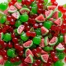 Colorful fruit-shaped gummy candies in a pile on a light countertop