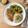 A balanced home-cooked plate with grilled chicken, vegetables, and brown rice
