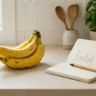 Ripe bananas on a kitchen counter next to a notepad