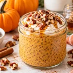 Creamy pumpkin chia pudding topped with yogurt and pecans