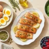 Eggs, salmon, spinach, pumpkin seeds, and berries arranged on a wooden table