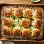 Tray of baked Italian grinder sliders with melted provolone and garlic butter topping" Emplacement : Image mise en avant