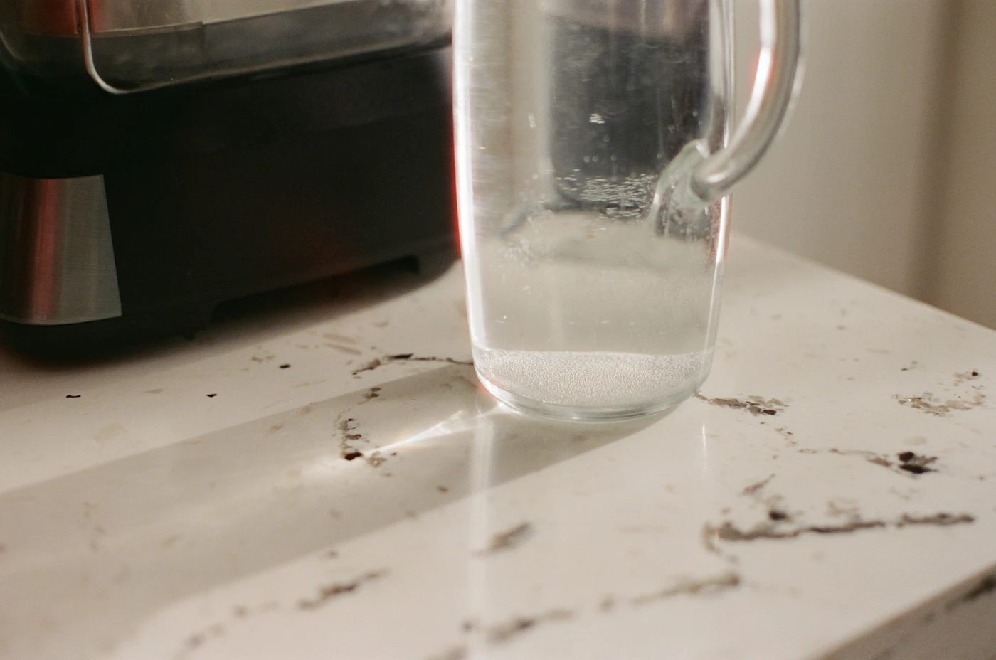 Clear glass pitcher of water on a countertop