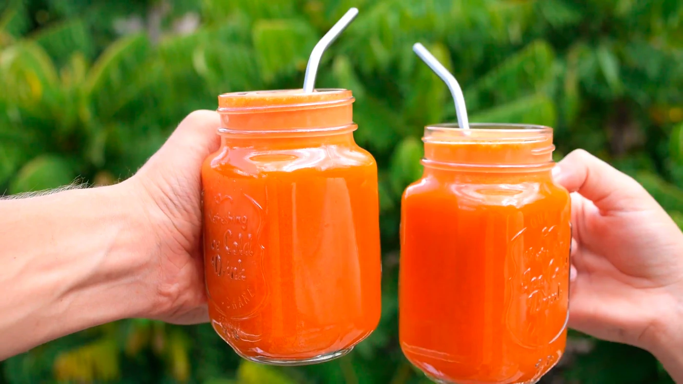Fresh orange carrot ginger juice in a glass