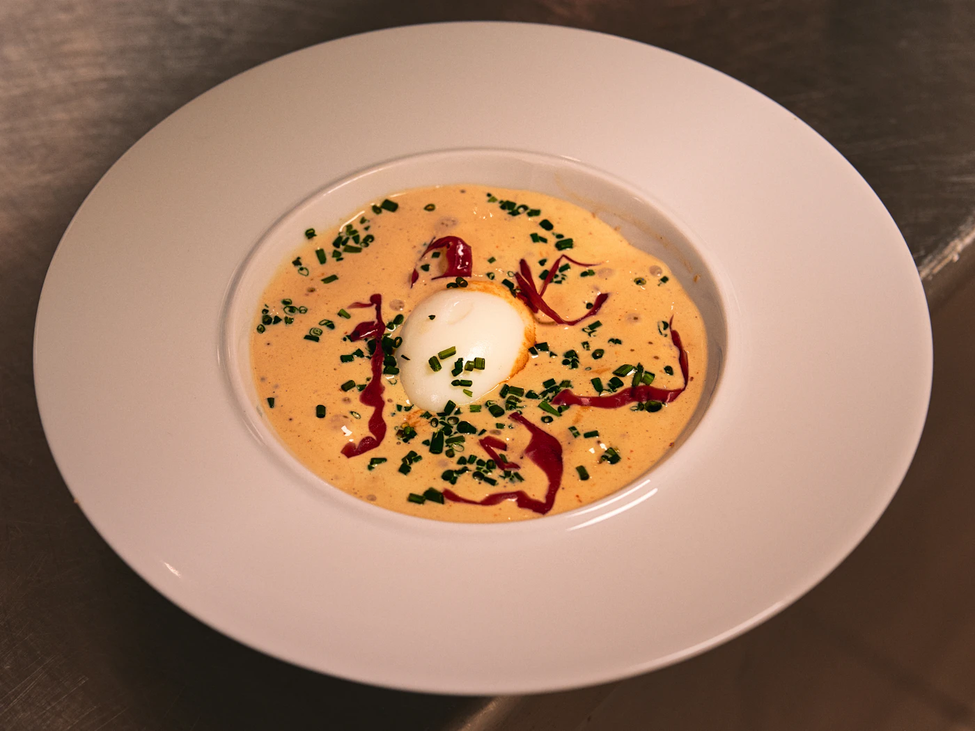 Creamy chicken soup with herbs in a bowl