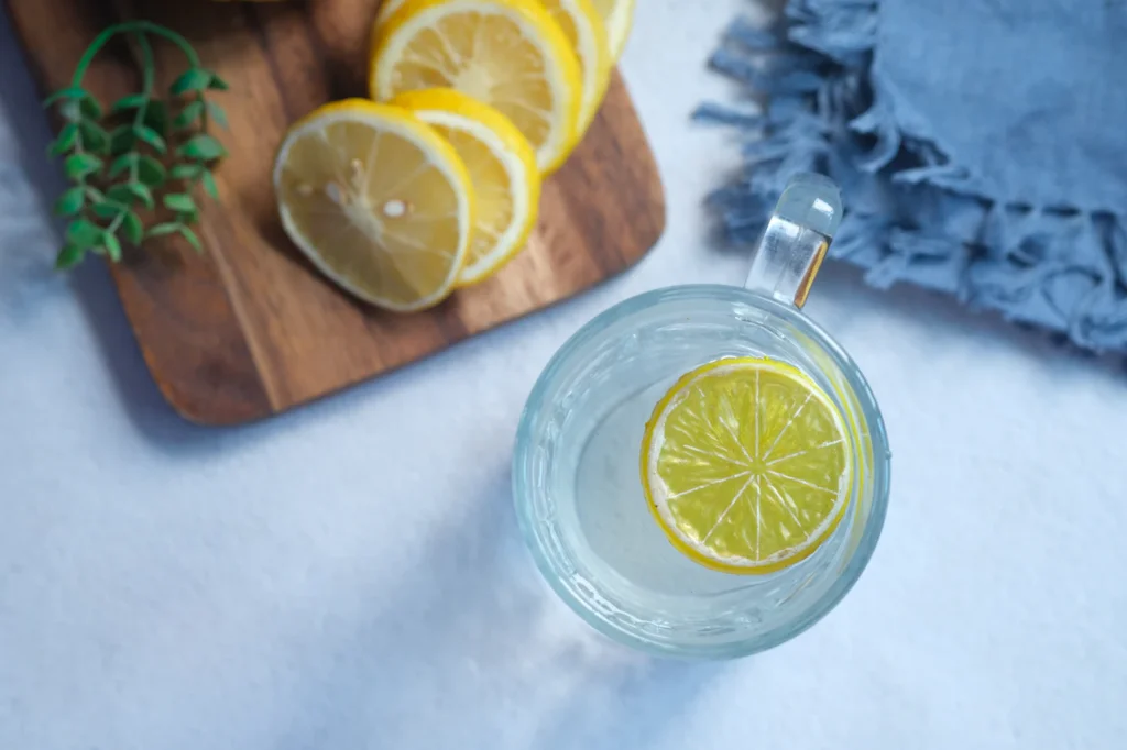 Glass of lemon water on a table illustrating the Dr Oz baking soda recipe trend