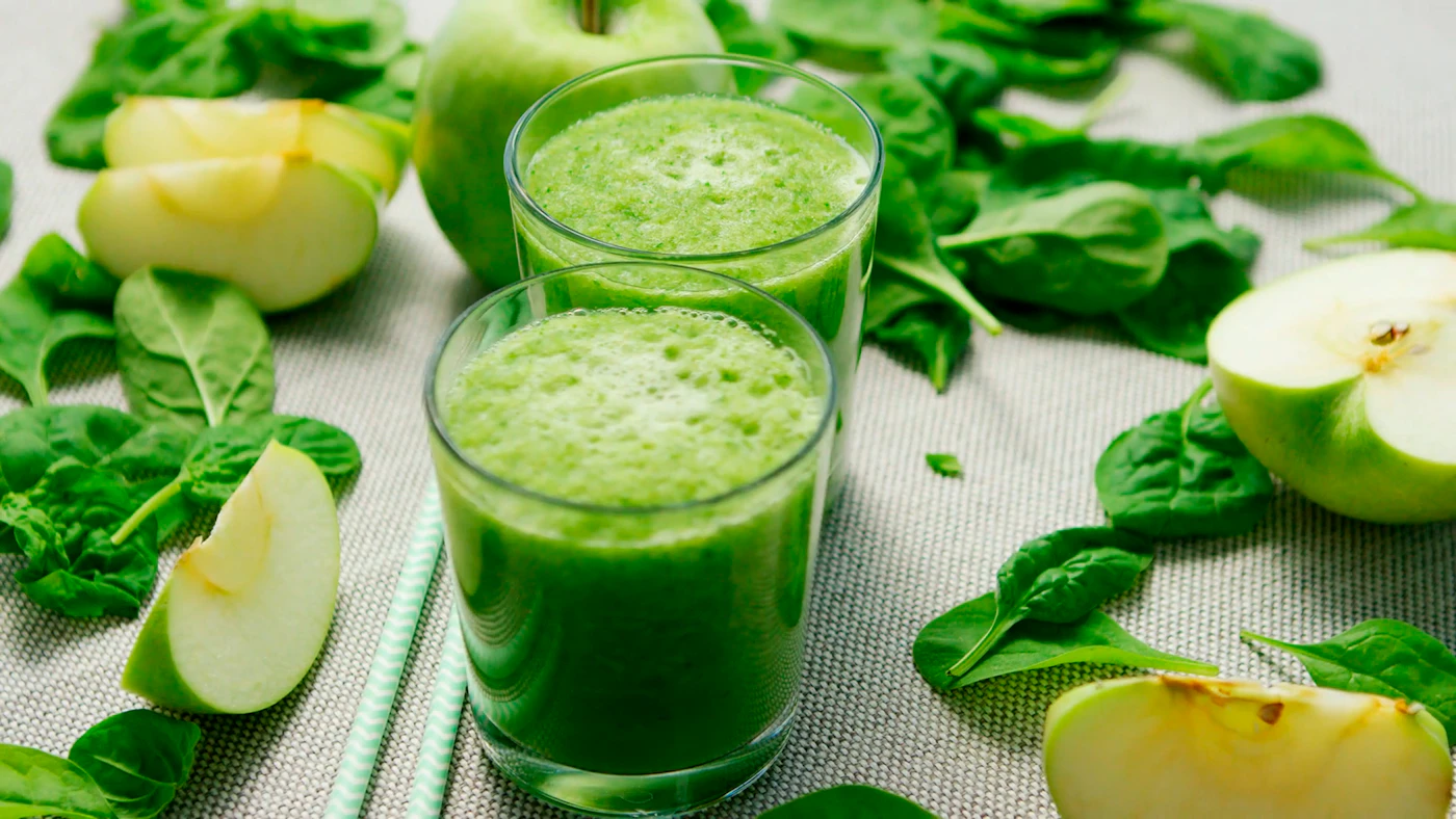 Fresh green vegetable juice in a clear glass