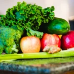 Fresh green juice being prepared with leafy vegetables
