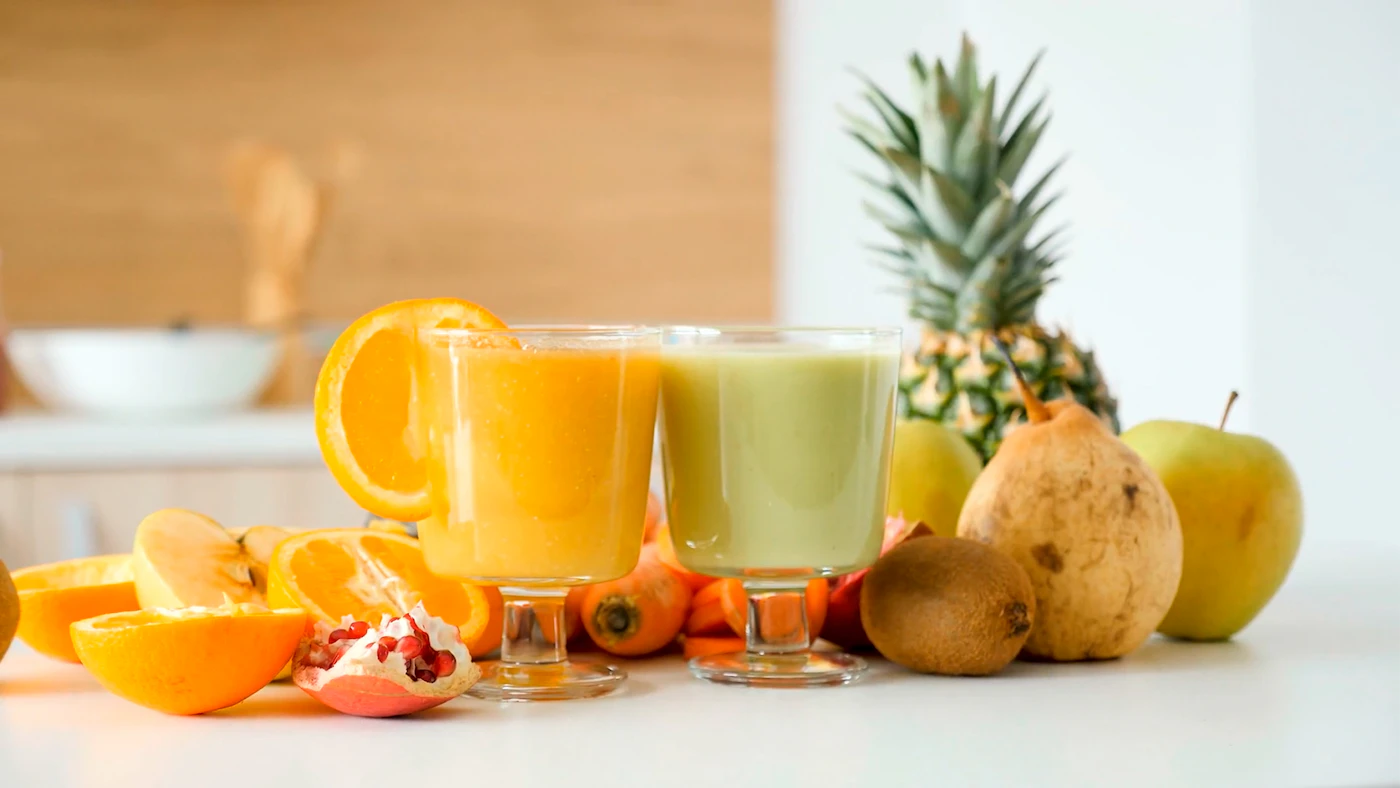 Fresh yellow fruit and vegetable juice in a clear glass