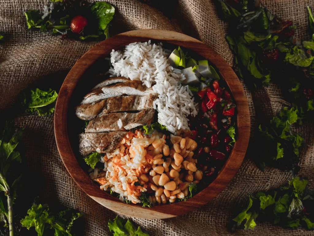 High-protein high-fiber meal bowl with chicken, rice, beans and vegetables