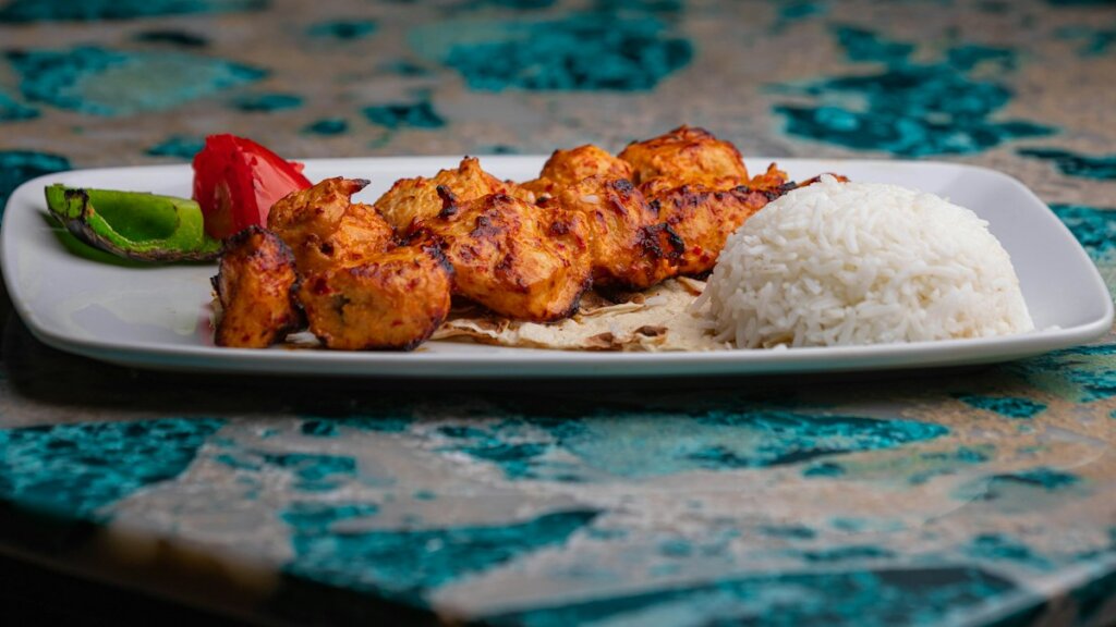 Mediterranean-style lunch plate with chicken, rice and salad for meal prep